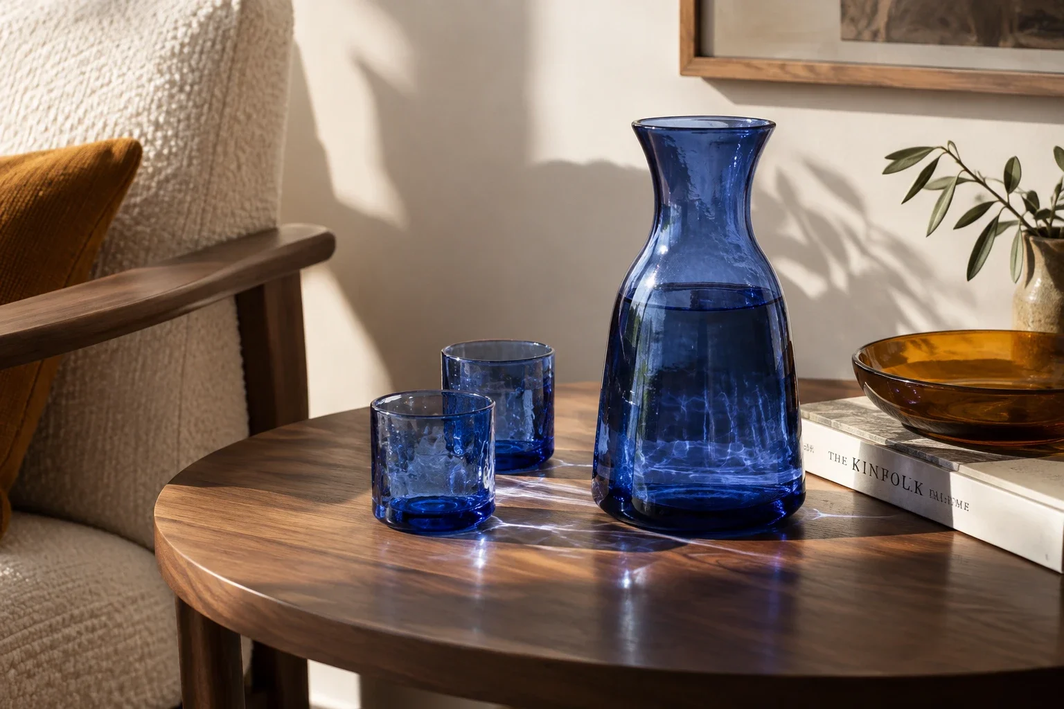 A product in believable light — A glass carafe and tumblers bring reflections, shadow, and transparent material into the same brief.