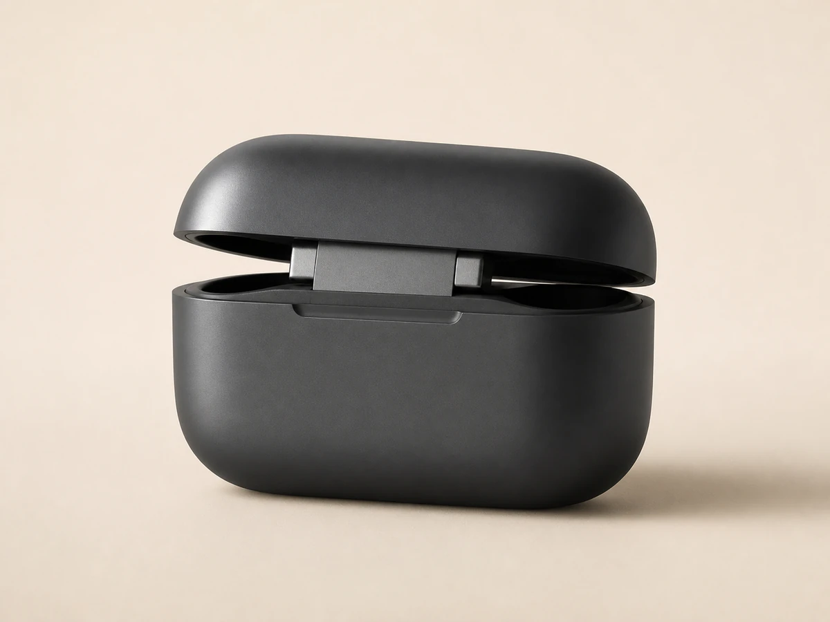 Graphite headphone charging case showing matte edges, seam, and metal hinge detail